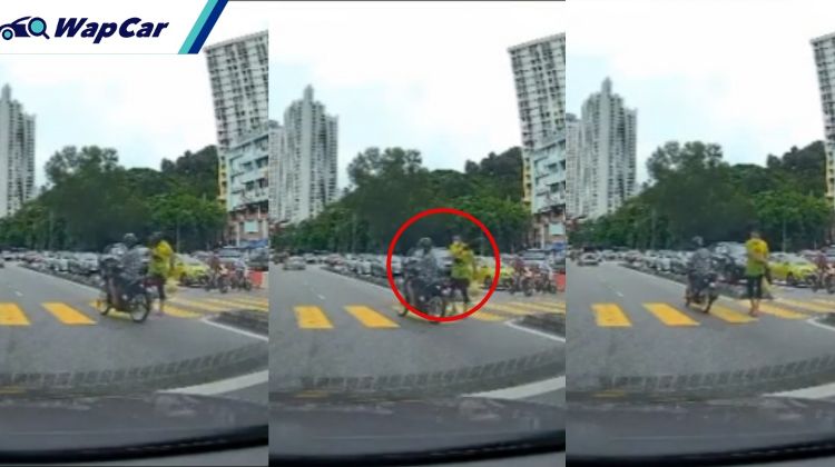Video: Elderly pedestrian flings bag at motorcyclist for jumping red light